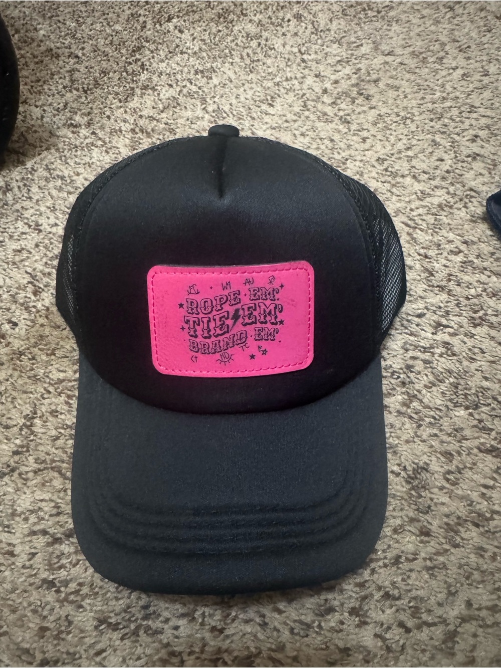 Rope 'Em Tie 'Em Black Trucker Hat with Pink Patch